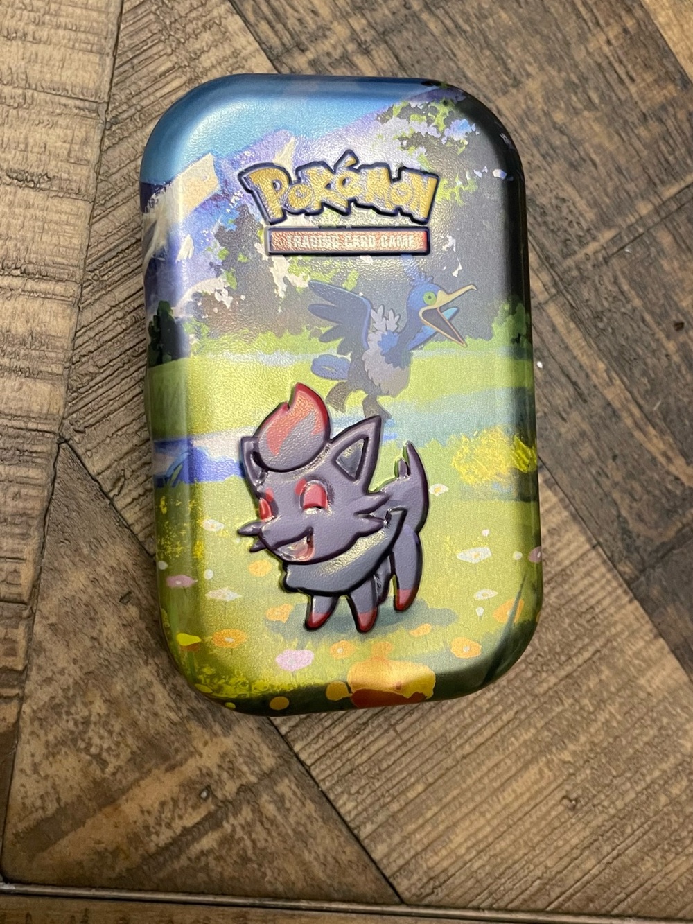 Pokémon TCG:metal tin featuring Zorua-listing for 1 tin and sticker only